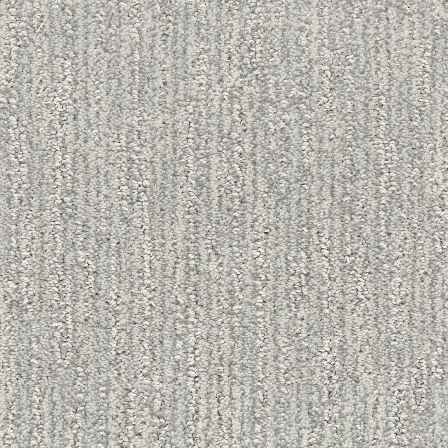 Close-up of Contentment Pet Friendly Carpet in light gray, featuring a subtle textured pattern with vertical, wavy lines for a soft, neutral look; stain-resistant and ideal for homes with pets.