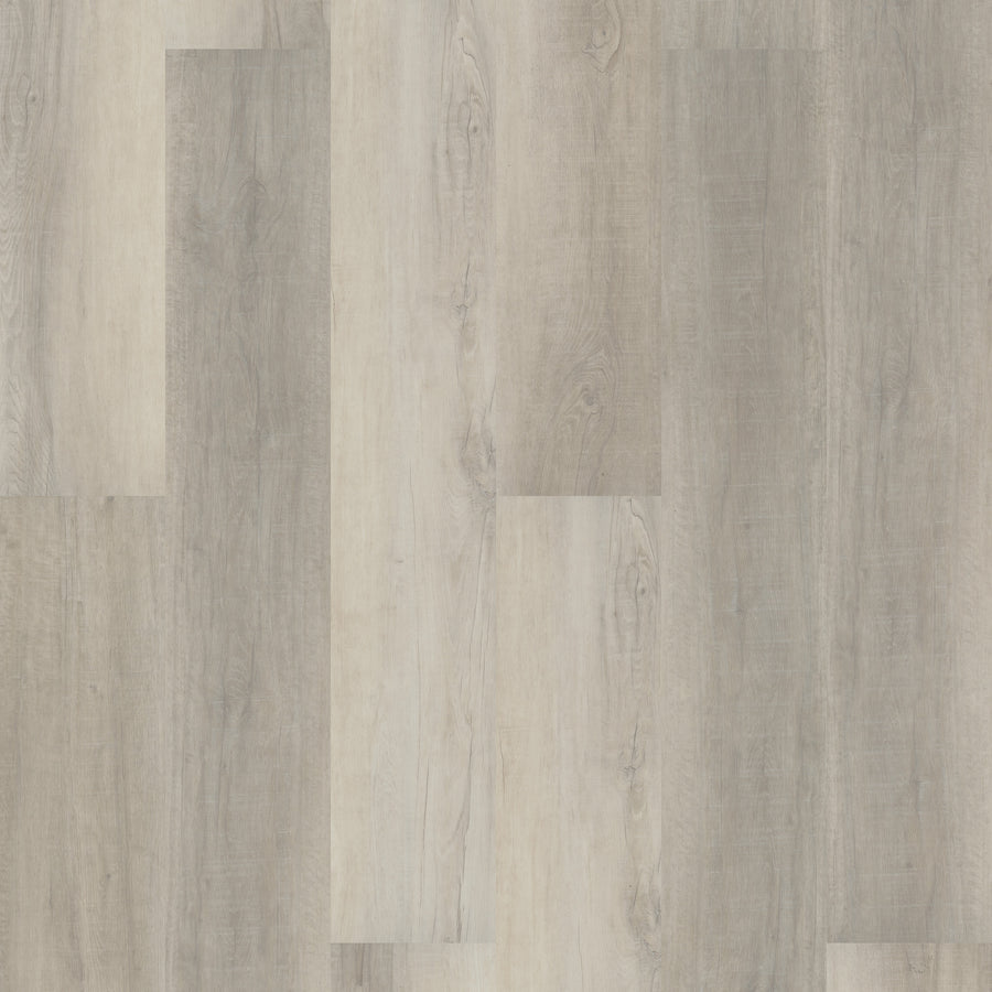A close-up of Coretec Pro Plus XL Enhanced Vinyl shows light and medium gray wood-look flooring with natural grain, subtle knots, and color variations—perfect for stylish, waterproof floors.