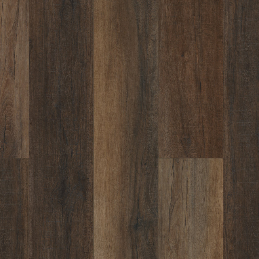 Close-up of Coretec Pro Plus XL Enhanced Vinyl panels in various brown tones, showcasing natural wood grain patterns and smooth textures aligned vertically for stunning wood and stone visuals.