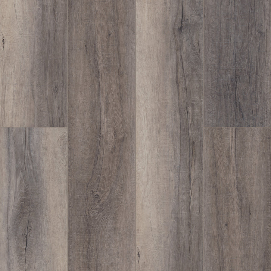 A close-up of Coretec Pro Plus XL Enhanced Vinyl planks in gray and brown shades, showcasing natural wood grain and knots. This waterproof flooring blends wood and stone looks in a fashionable staggered layout.