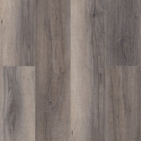 A close-up of Coretec Pro Plus XL Enhanced Vinyl planks in gray and brown shades, showcasing natural wood grain and knots. This waterproof flooring blends wood and stone looks in a fashionable staggered layout.
