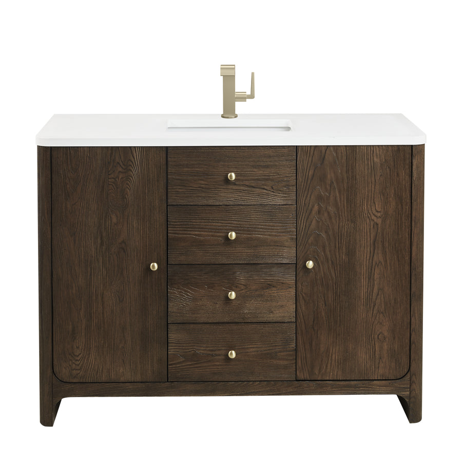 A bathroom vanity with a white countertop, built-in sink, gold faucet, and dark wood cabinet featuring four center drawers and two side doors with gold knobs.
