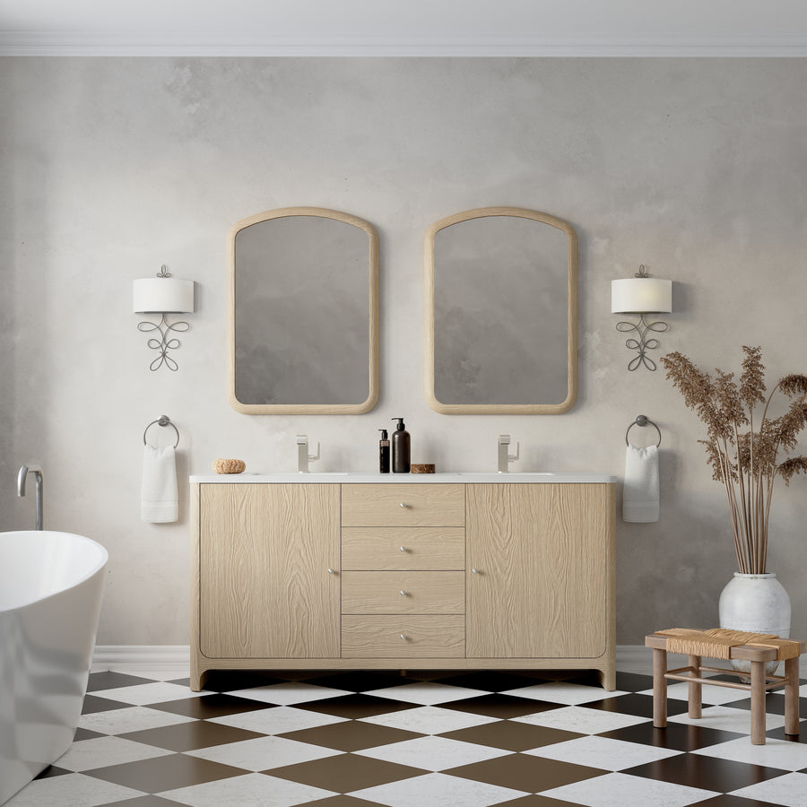 A modern bathroom features the Gracyn 72" Vanity, two mirrors, wall sconces, a white bathtub, black-and-white checkered flooring, and a vase with dried plants set next to two wooden stools.