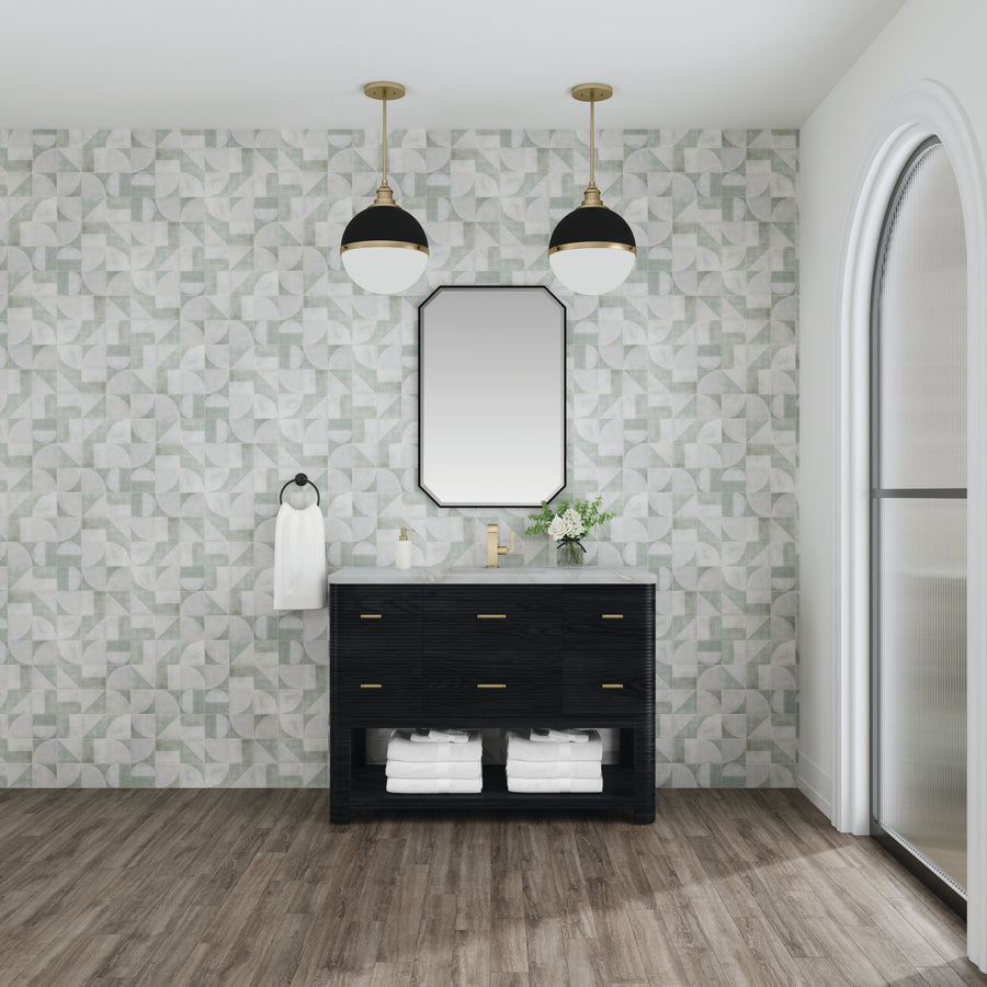Modern bathroom with geometric wall tiles, the Lucian 48" Vanity featuring gold fixtures, neatly folded white towels on the shelf, two round pendant lights, an octagonal mirror, and a large arched window.