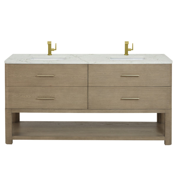 A modern double-sink bathroom vanity with a light wood finish, four drawers, an open lower shelf, and a white marble countertop. Two gold faucets are mounted above the sinks.