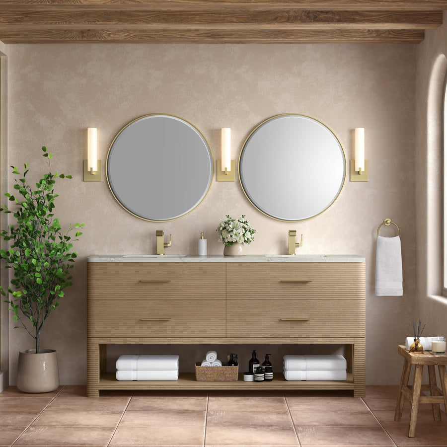 Modern luxury bathroom featuring the Lucian 72" Vanity, two round mirrors, gold fixtures, wall sconces, a potted plant, towels, and toiletries on open shelves—all set against beige walls and a tiled floor.