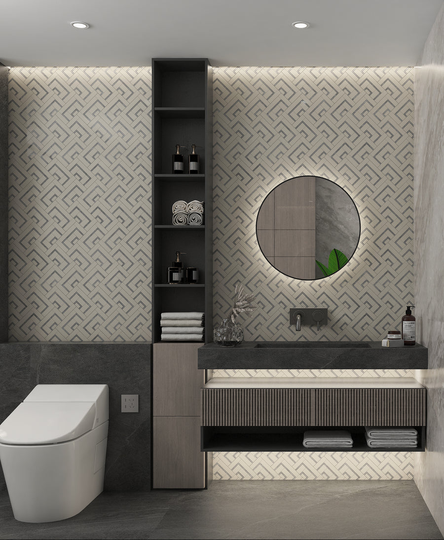 Modern bathroom with geometric patterned wall, round backlit mirror above a floating sink, open shelving with towels and toiletries, and a sleek white toilet. Soft ambient lighting enhances the contemporary design.