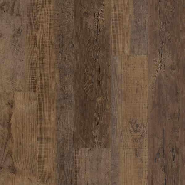 Close-up view of a Coretec Pro Plus Vinyl floor with wide planks in varied brown tones, showcasing visible grain patterns, knots, and textured surfaces for an authentic luxury flooring appearance.