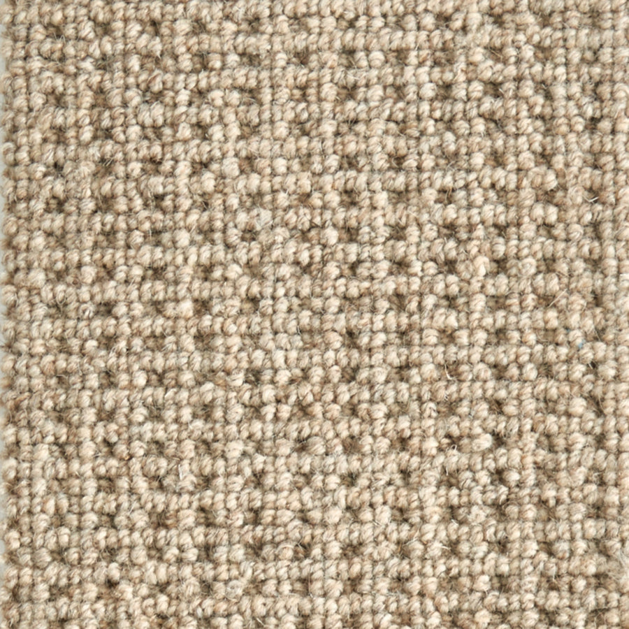 Close-up of Timbers Berber Carpet in Dakota Tan, featuring tightly woven looped pile for a contemporary look. The textured grid pattern showcases subtle color variations, adding modern style to any space.