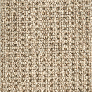 Close-up of Timbers Berber Carpet in Dakota Tan, featuring tightly woven looped pile for a contemporary look. The textured grid pattern showcases subtle color variations, adding modern style to any space.