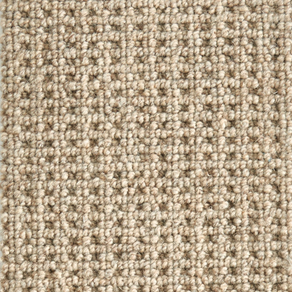Close-up of Timbers Berber Carpet in Dakota Tan, featuring tightly woven looped pile for a contemporary look. The textured grid pattern showcases subtle color variations, adding modern style to any space.