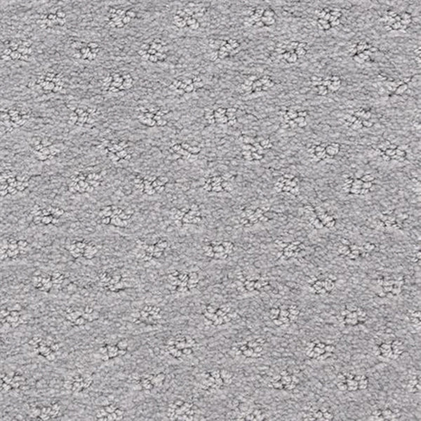 Close-up of the Dreamer On Trend Carpet in Davy Gray, showing a light gray textured surface with subtle dotted pattern and evenly spaced plush tufts—an inviting option for luxury flooring.