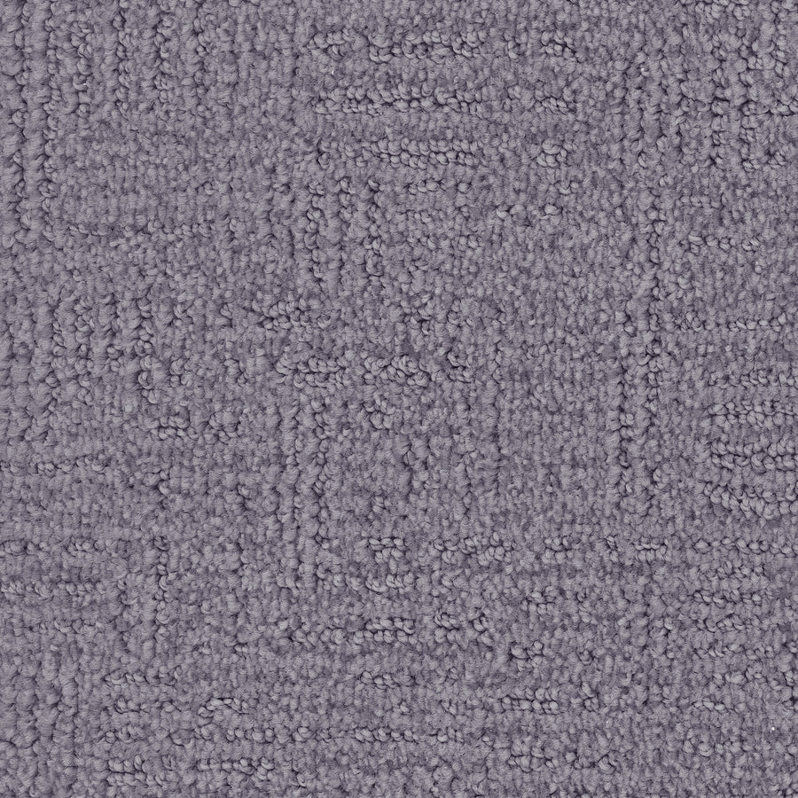 Close-up of Distinctive Family Friendly Carpet—textured purple flooring with a subtle geometric pattern and tightly woven fibers, crafted from Envision nylon for stylish, durable home decor.