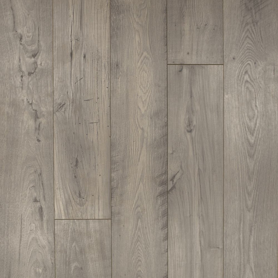 Close-up view of Rare Vintage 7 1/2" Waterproof Laminate in Doeskin Chestnut, featuring grayish-brown tones, visible wood grain patterns, knots, and subtle texture variations running vertically across the planks.