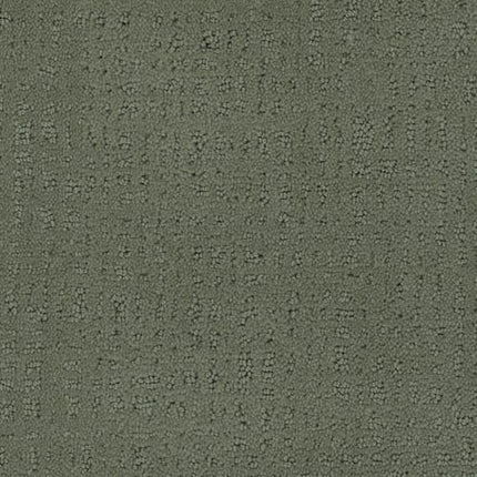 Close-up of Homage Berber Carpet in Dolce, featuring an olive green shade with a subtle geometric dot pattern and textured, raised surface—ideal for high-traffic areas.