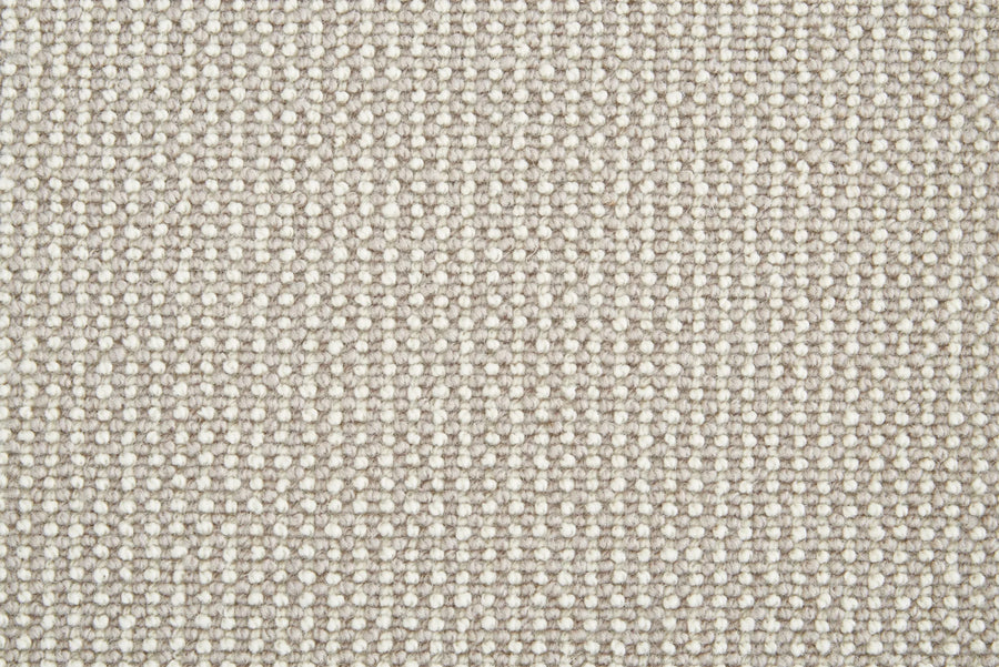 Close-up of Harper Berber Carpet in Dove color, showing its grid-like woven texture. The tightly knit fibers provide everyday durability and a sturdy surface, making it ideal for long-lasting comfort.