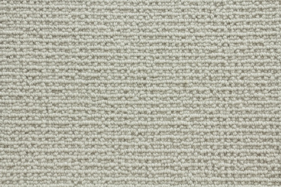 Close-up of Sequoia Berber Carpet in Dove color, highlighting its textured, horizontal looped pattern and soft woven look—crafted from premium materials for durable flooring in high-traffic areas.