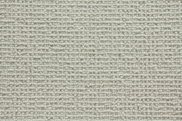 Close-up of Sequoia Berber Carpet in Dove color, highlighting its textured, horizontal looped pattern and soft woven look—crafted from premium materials for durable flooring in high-traffic areas.