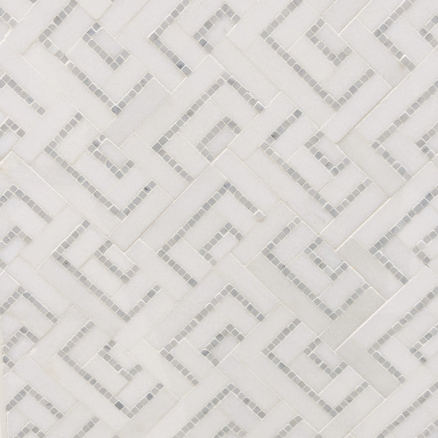 A close-up of Duccia Polished Marble Tile shows white mosaic squares forming interlocking geometric shapes and lines, creating a modern, textured pattern.