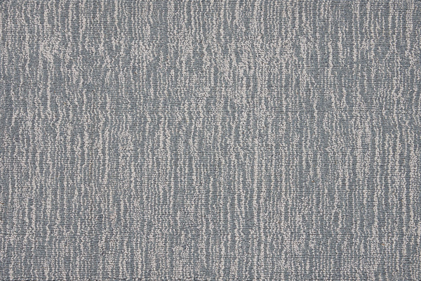 Close-up of the Effervescense On Trend Carpet in Azure, featuring irregular vertical white lines on a blue-gray background for a modern, abstract look with contemporary elegance.