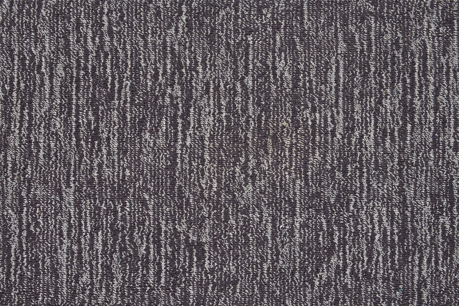 Close-up of Effervescense On Trend Carpet in Graphite, showcasing a plush, dense surface with dark and light gray fibers in an irregular vertical stripe design. The soft texture highlights its contemporary appeal.