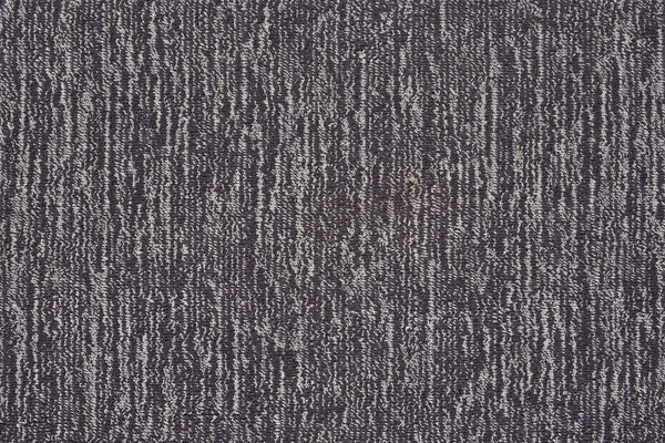 Close-up of Effervescense On Trend Carpet in Graphite, showcasing a plush, dense surface with dark and light gray fibers in an irregular vertical stripe design. The soft texture highlights its contemporary appeal.