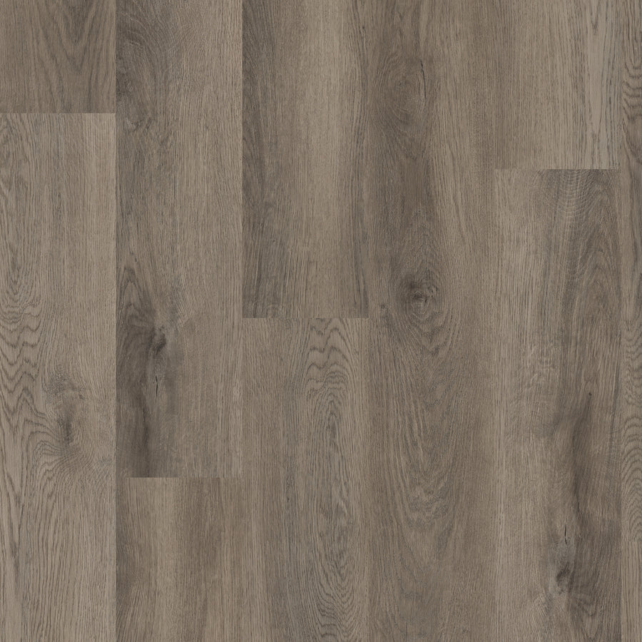 Close-up view of Coretec Pro Plus Vinyl flooring in medium brown, showing visible grain patterns and knots for a natural, textured look—ideal for those wanting waterproof flooring with luxury appeal.