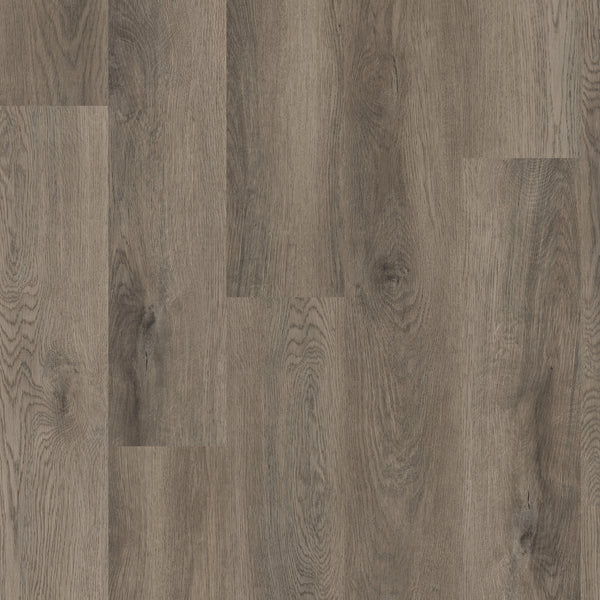 Close-up view of Coretec Pro Plus Vinyl flooring in medium brown, showing visible grain patterns and knots for a natural, textured look—ideal for those wanting waterproof flooring with luxury appeal.