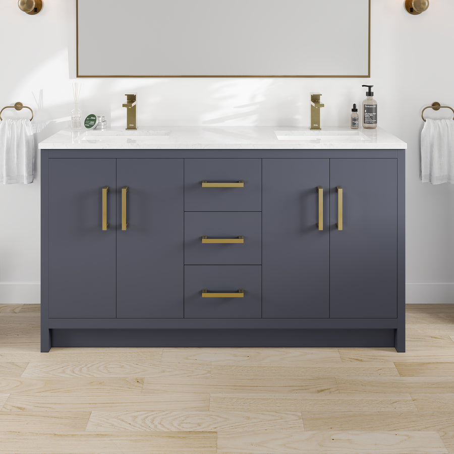 Curio 60″ Vanity in Dark Blue features gold hardware, double sinks, a white Carrara quartz top, and is paired with light wood flooring. A soap dispenser and small decorative accents are placed by the faucets for an elegant finish.