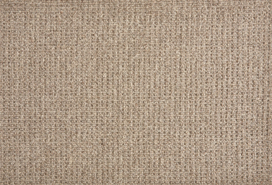 Close-up of the Martina Berber Carpet in Earth color, featuring a soft, textured grid-like pattern. Its durable, slightly raised surface provides warmth and comfort—perfect for high-traffic areas in your home or office.