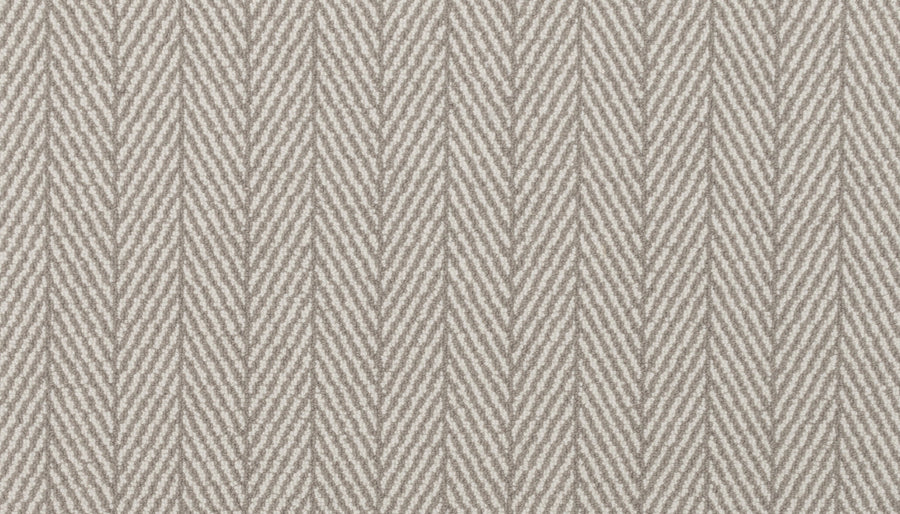 The Eastleigh Berber Carpet in Platinum features a luxury herringbone pattern with diagonal V-shaped lines, offering an elegant and durable option for high-traffic areas.