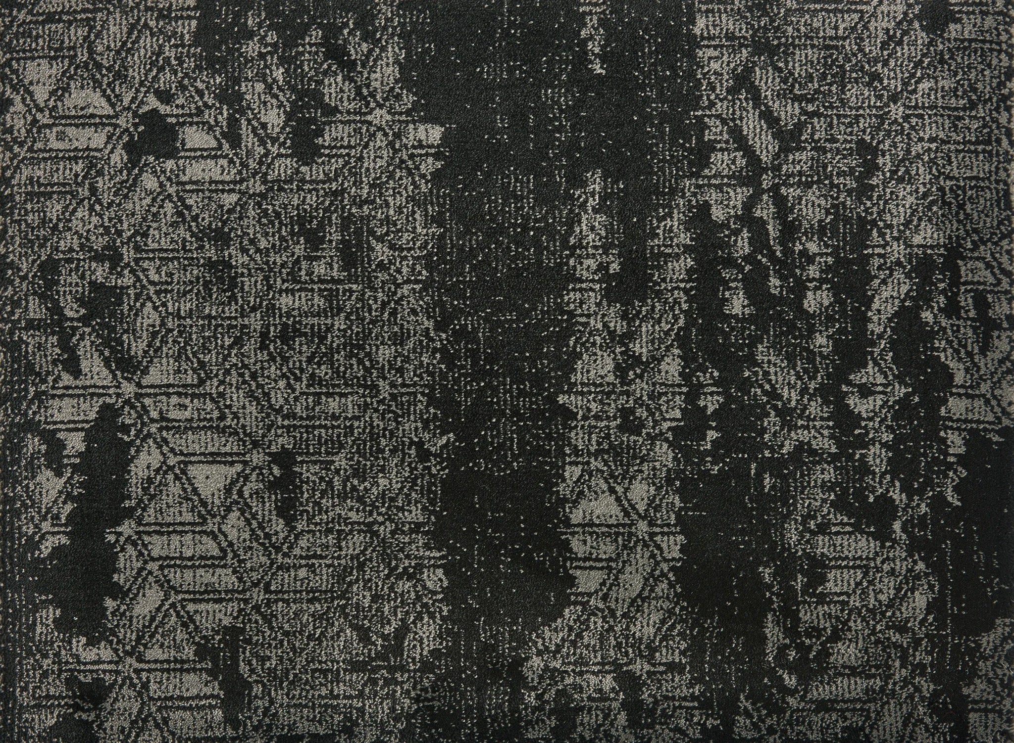 
		                            Delphi On Trend Carpet in Ebony features a textured fabric with a distressed, abstract black and gray pattern, including subtle zigzags and geometric shapes with vertical streaks—perfect for elegant, modern flooring.
		                            