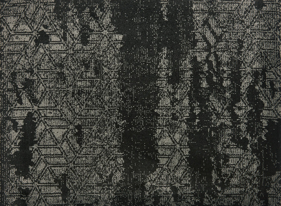 Delphi On Trend Carpet in Ebony features a textured fabric with a distressed, abstract black and gray pattern, including subtle zigzags and geometric shapes with vertical streaks—perfect for elegant, modern flooring.