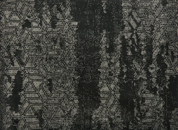 Delphi On Trend Carpet in Ebony features a textured fabric with a distressed, abstract black and gray pattern, including subtle zigzags and geometric shapes with vertical streaks—perfect for elegant, modern flooring.