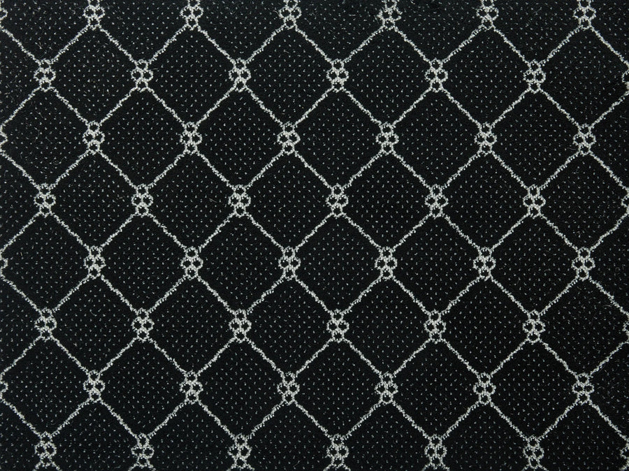 The Lake Boden Berber Carpet in Ebony features a black surface with a geometric diamond pattern of white intersecting lines and circular accents—an ideal choice for modern home flooring that balances style with durable performance.