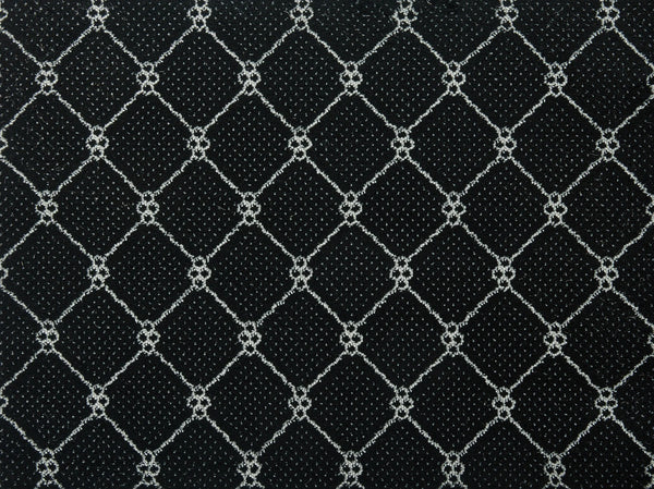 The Lake Boden Berber Carpet in Ebony features a black surface with a geometric diamond pattern of white intersecting lines and circular accents—an ideal choice for modern home flooring that balances style with durable performance.