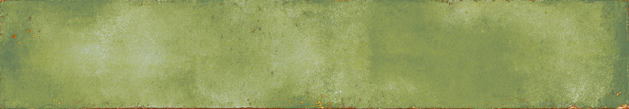 The Eclipse 2x18 Glazed Porcelain Tile features a rectangular shape, weathered green tones, a textured mottled finish, and subtle rust or brown edges for an aged rustic look.