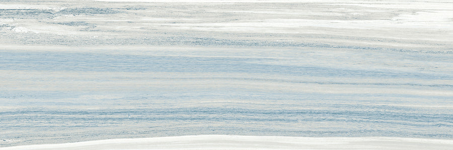 Element 10x30 Glossy Tile features horizontal wavy layers in soft blue, white, and gray tones, with a calm, flowing pattern that resembles natural stone.