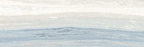Abstract image with soft white, light gray, and pale blue layers evokes watercolor brushstrokes and serene landscapes, featuring subtle textures that suggest the refined elegance of Element 4x12 Glossy Tile in a tranquil setting.