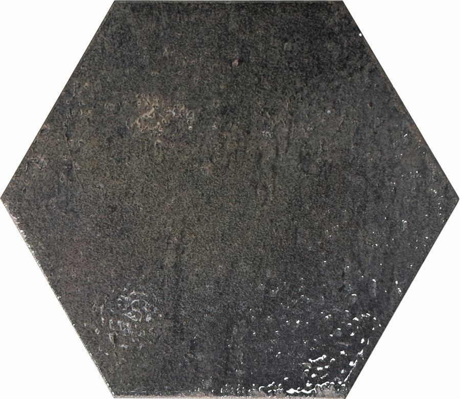 The Emerge 8x9 Hexagon Porcelain Tile in Eclipse offers a glossy, dark gray finish with relaxed beauty, natural variation, and a subtly textured, uneven surface.