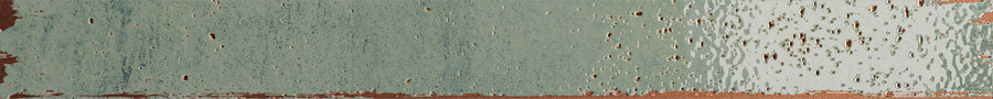 The Emerge 2x20 Porcelain Tile in Sprout features a pale green and copper brushstroke look with a distressed, weathered finish, uneven edges, and blended colors for an artistic, textured appearance.