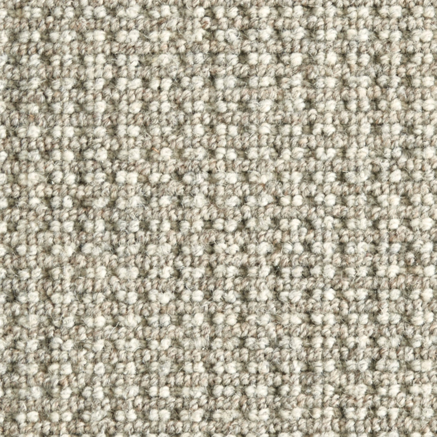 Close-up view of Timbers Berber Carpet in Etched Pewter, featuring a textured loop-pile and subtle woven pattern. Its tightly packed fibers provide a soft feel and durable finish, perfect for contemporary flooring.