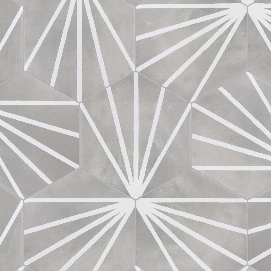 Hexagonal tiles in shades of gray with white geometric sunburst patterns radiating from each center, creating a repeating modern design.