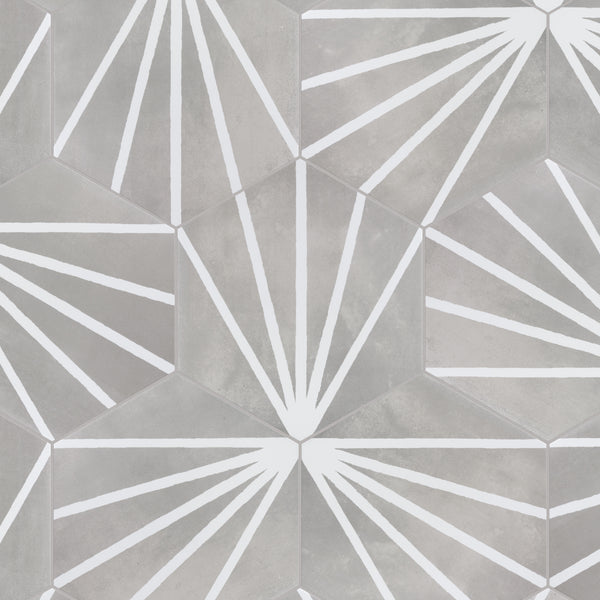 Hexagonal tiles in shades of gray with white geometric sunburst patterns radiating from each center, creating a repeating modern design.