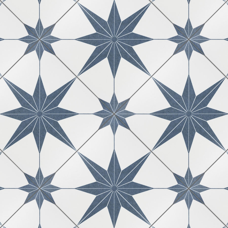 Geometric tile pattern featuring navy blue eight-pointed stars arranged in a grid on a white background, with the stars connected at their points, creating a seamless, symmetrical design.