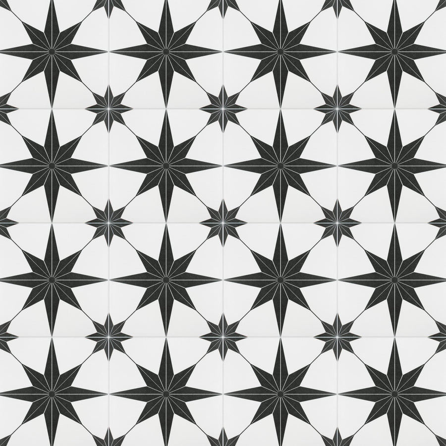 A repeating pattern of black eight-pointed stars on a white background, arranged in a grid. Each star has sharp, elongated points, creating a geometric and symmetrical design.