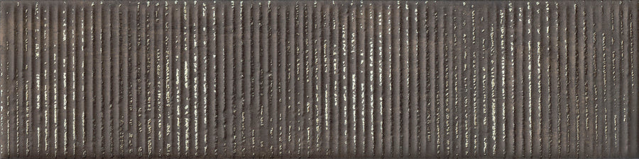 Urban Glow 4" x 16" Deco Subway Tile in Iron features a textured, dark matte surface with closely spaced vertical metallic lines, creating a modern shimmer reminiscent of elongated subway tiles.