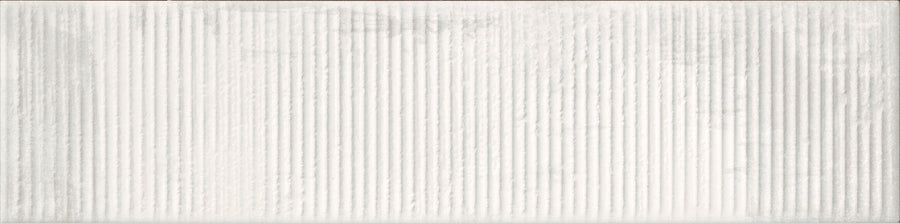 Urban Glow 4" x 16" Deco Subway Tile in Lunar features a textured white surface with vertical, evenly spaced ridges, creating a modern look similar to elongated subway or ribbed wall tiles.