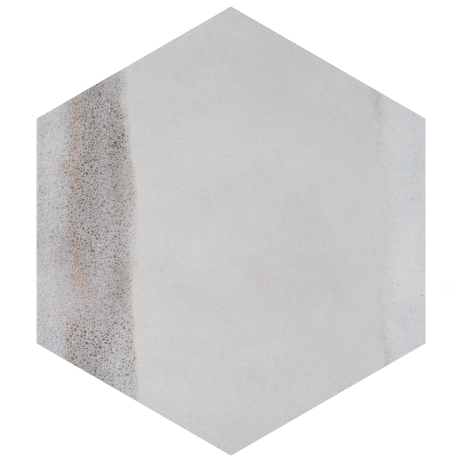 A hexagonal tile with a smooth, light gray surface featuring a subtle vertical stripe of textured, brown speckles along the left side.