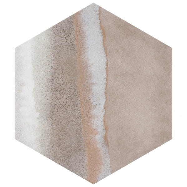 Hexagonal tile with a pattern resembling a sandy beach, featuring beige and tan tones with a white, foamy strip running diagonally, mimicking waves meeting the shore.